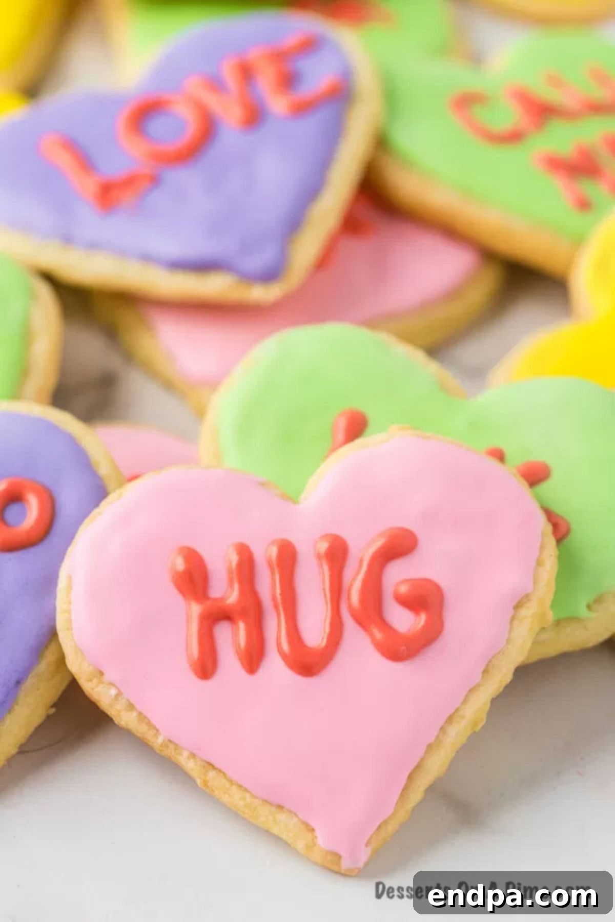 A delightful arrangement of freshly baked Valentine's Day sugar cookies, beautifully decorated and ready to be enjoyed.