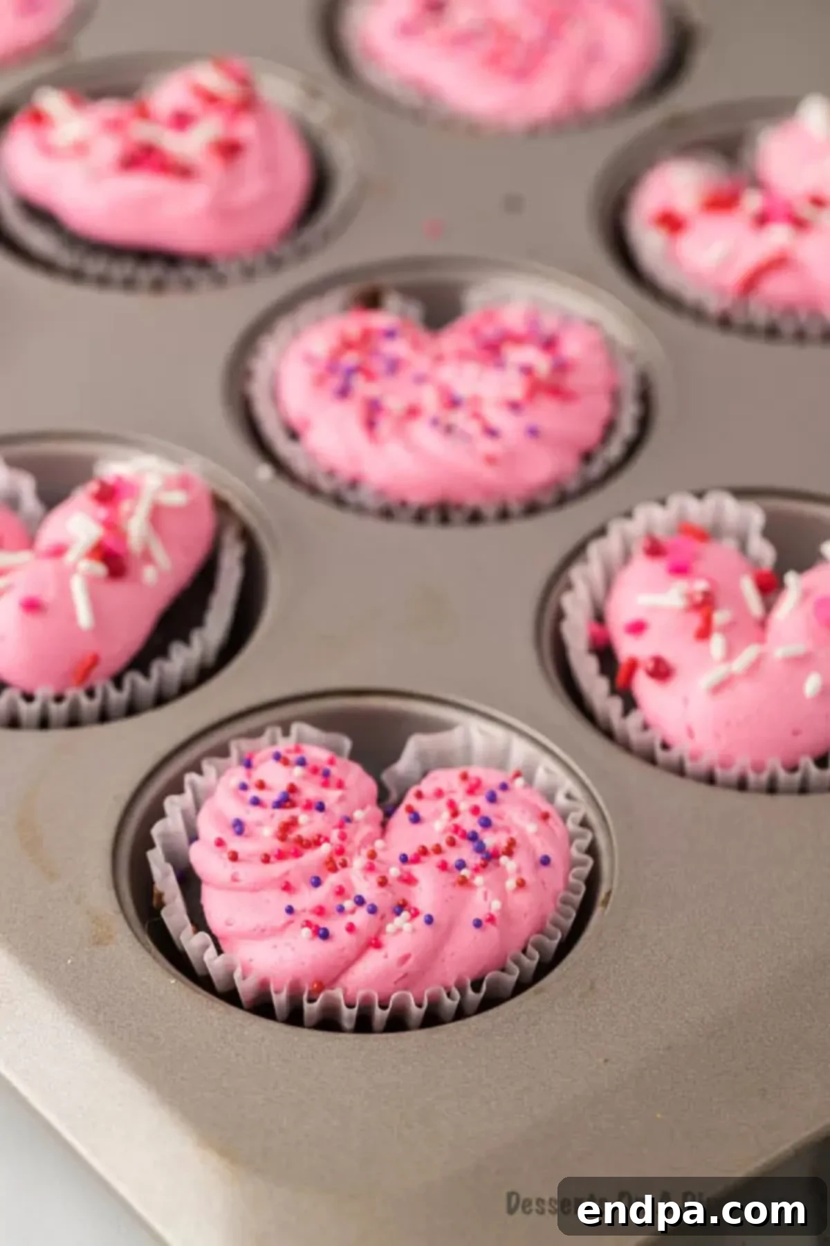 Cupid's Cupcakes 12 Beautifully decorated heart-shaped cupcakes on a platter, ready to be served.