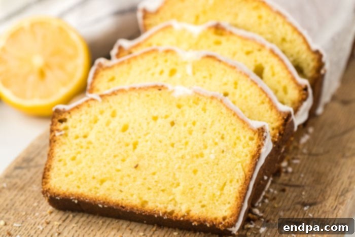 Starbucks Famous Lemon Loaf At Home 2 Lemon loaf sliced on a wooden board, ready to be served with a cup of coffee.