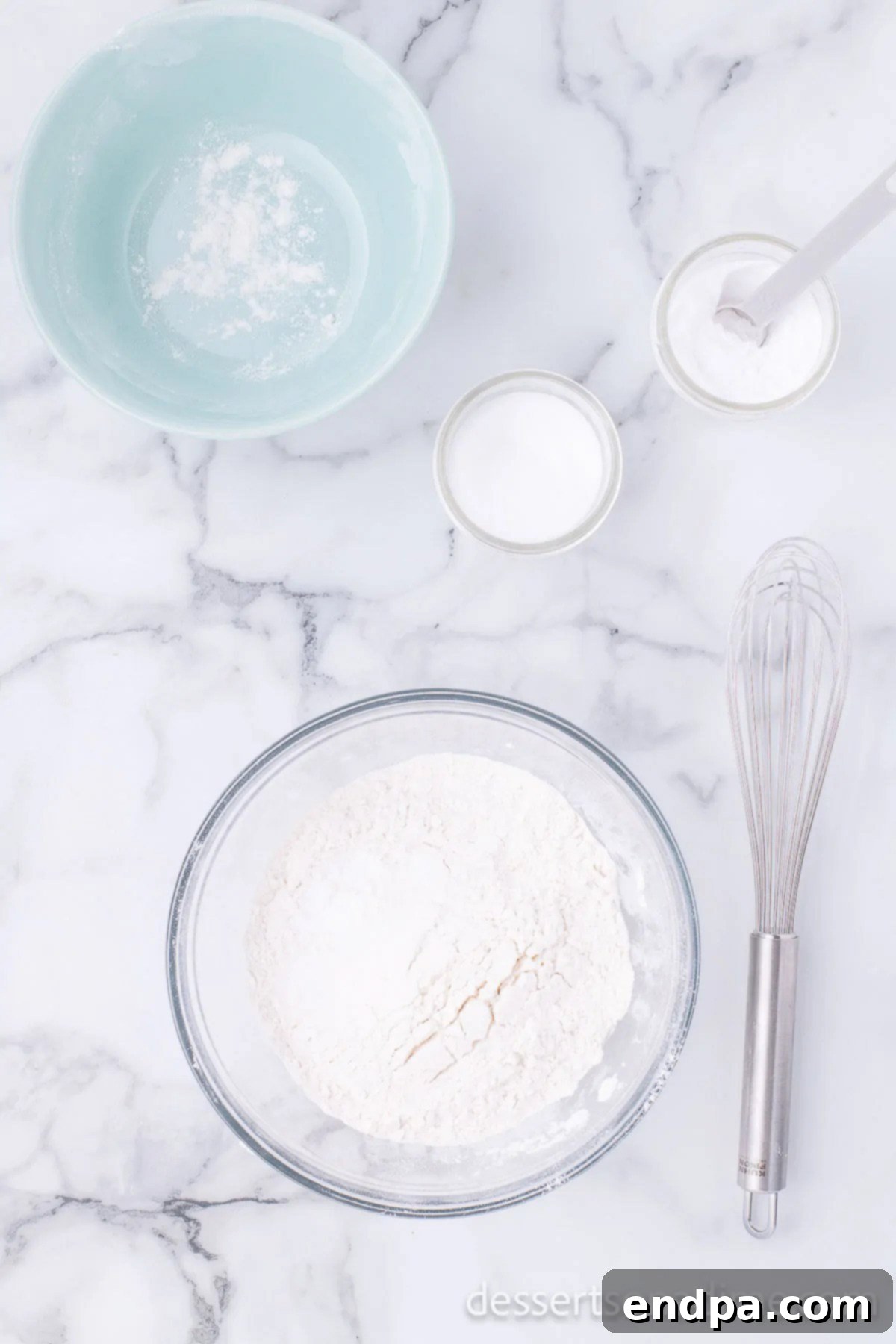 A separate mixing bowl containing dry ingredients: flour, baking soda, and salt, ready to be combined with the wet mixture.