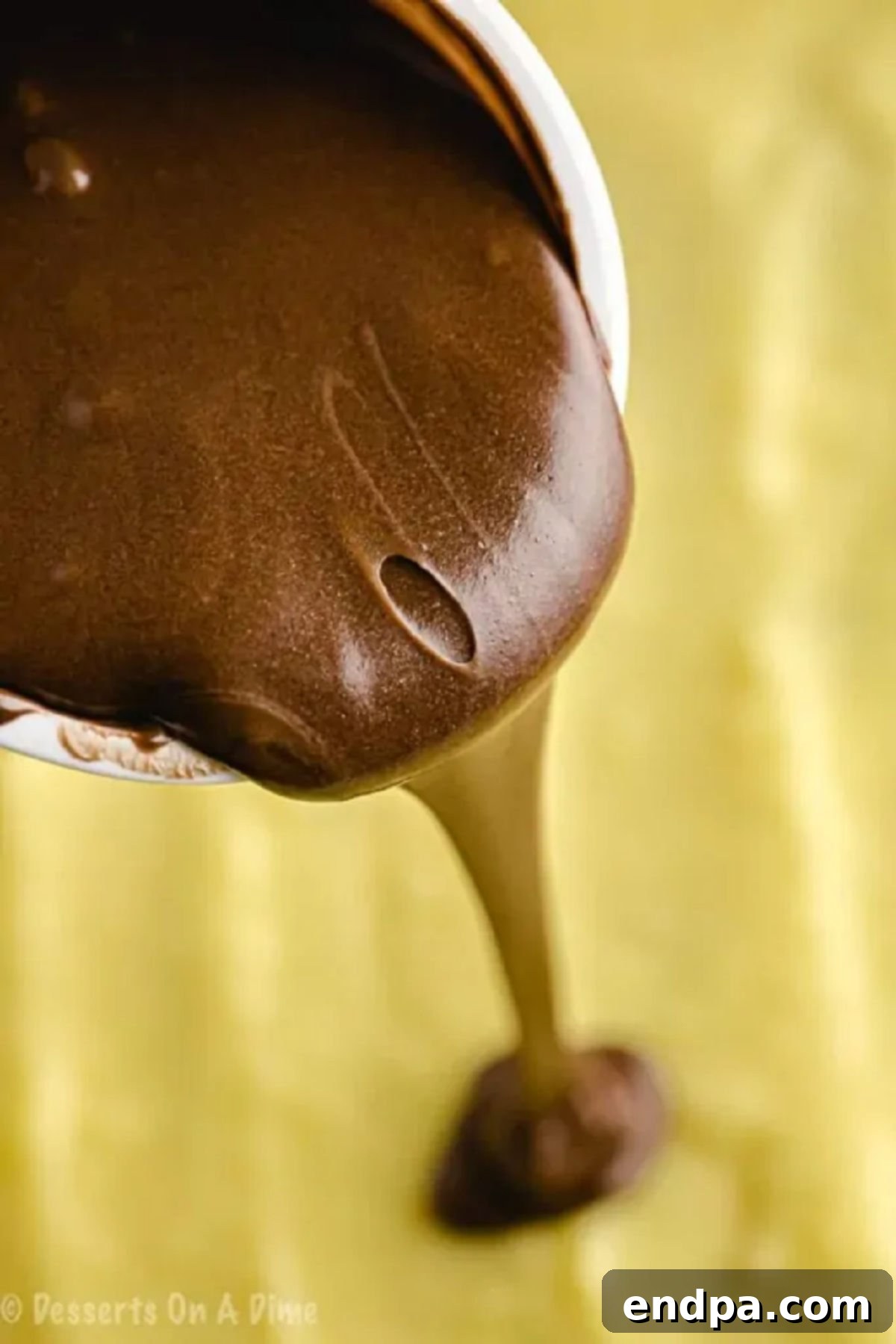 Chocolate frosted melted and poured over the pudding layer. 