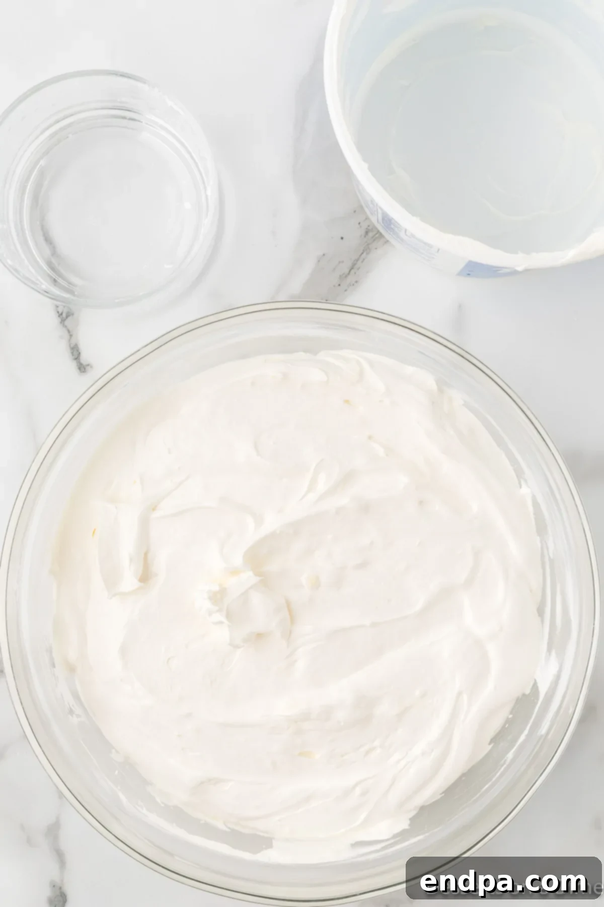 Cream cheese and butter combined in a bowl.