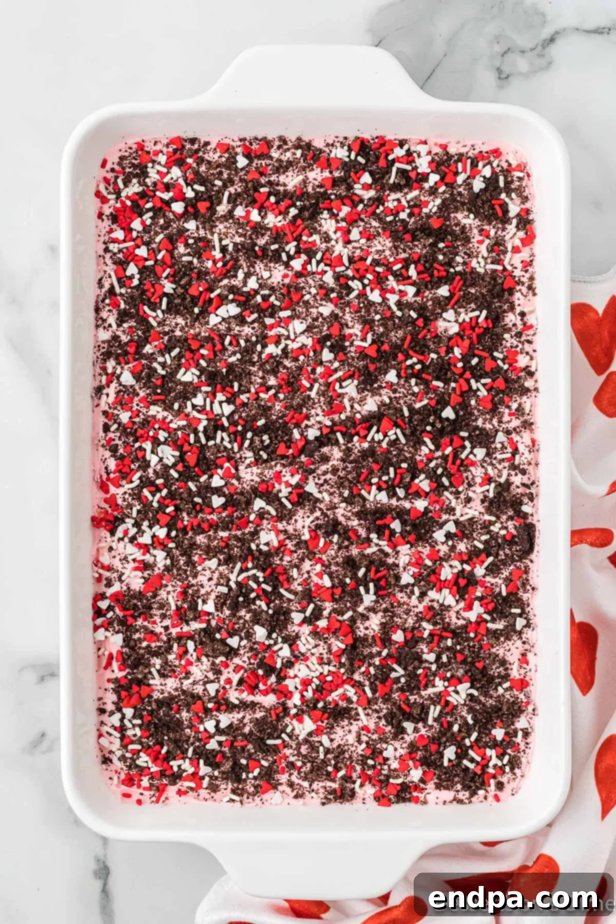 Sprinkles and crushed cookies on top of mixture.