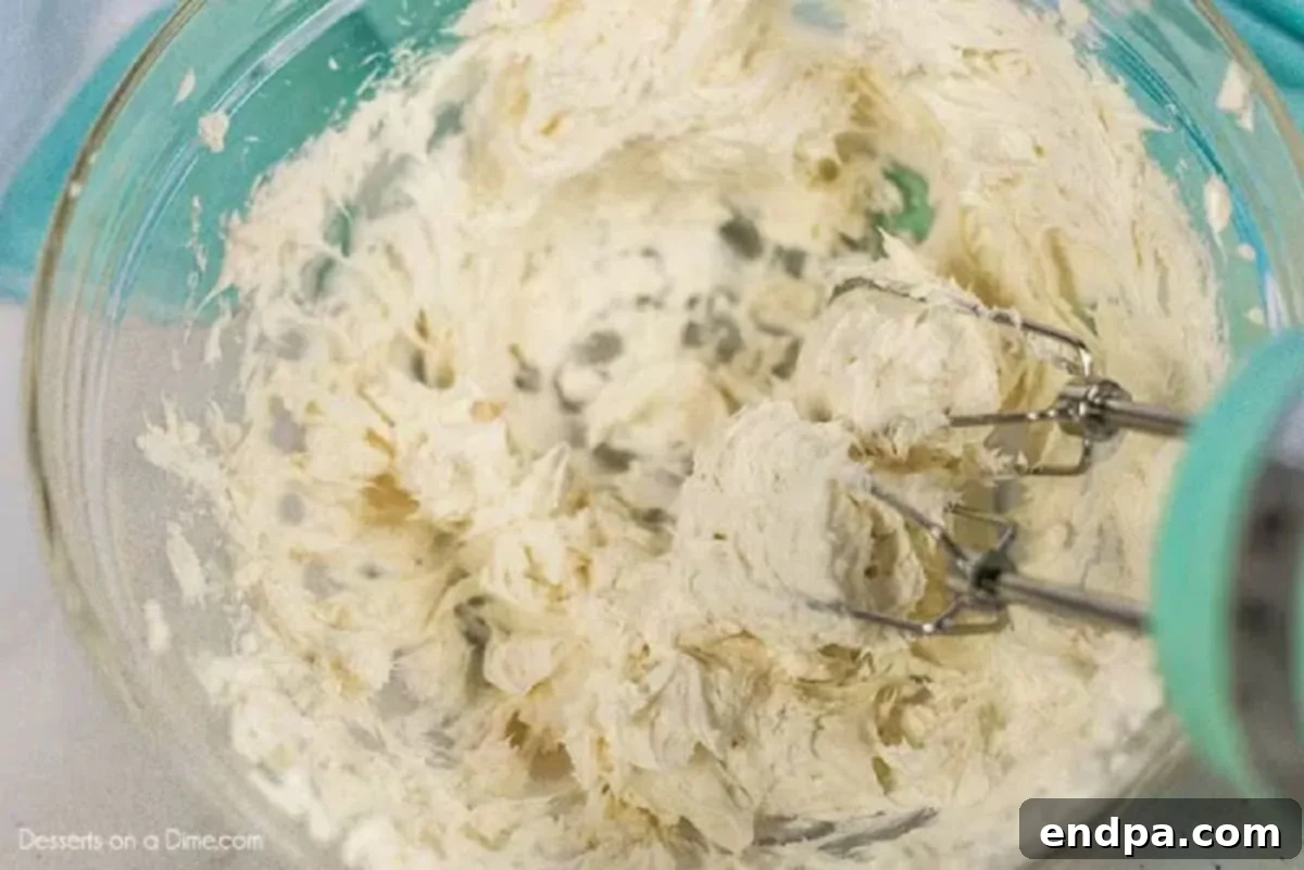 Spring Garden Dirt Cake 3 Cream cheese and butter mixture blended smooth in a mixing bowl.