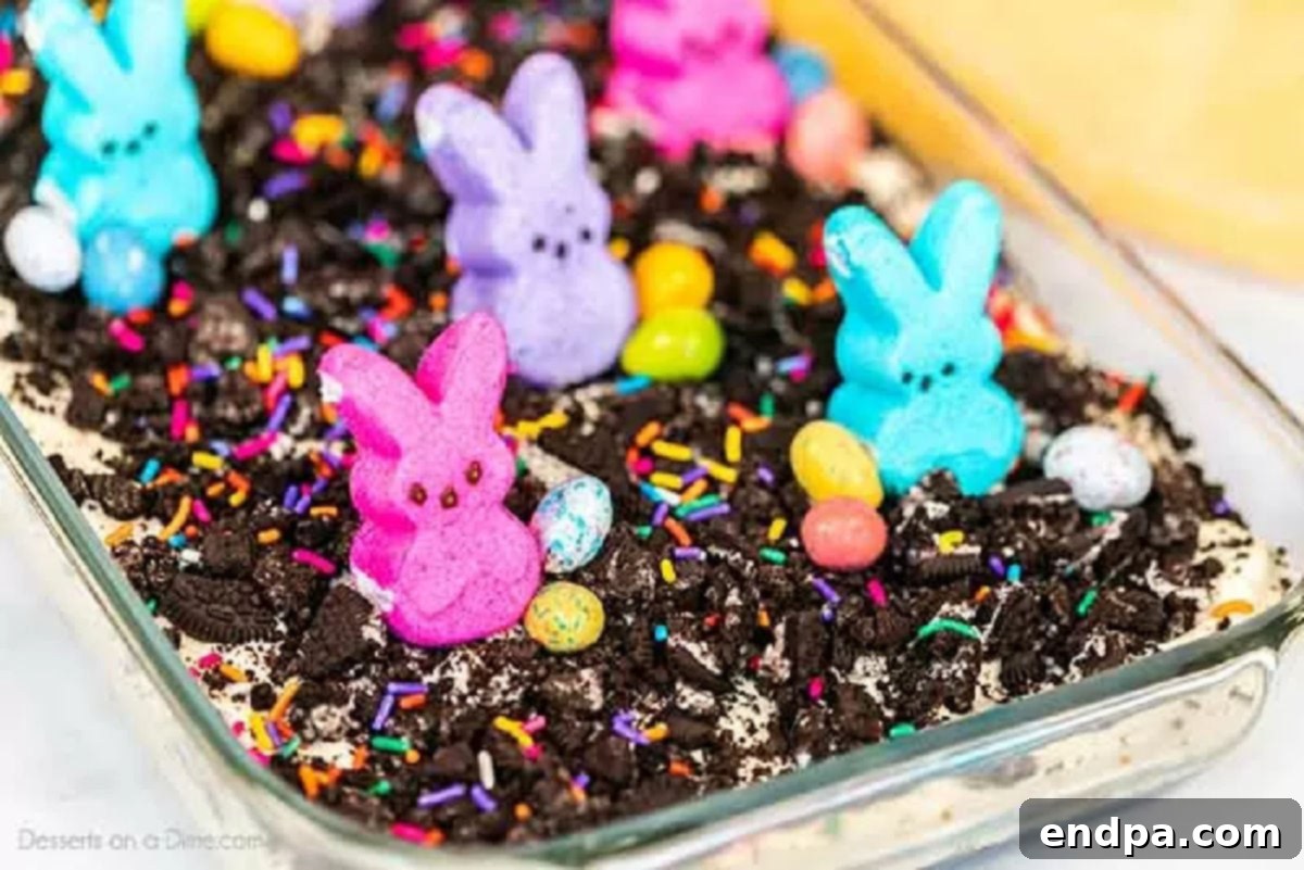 Spring Garden Dirt Cake 7 Easter dirt cake garnished with a variety of Easter candies, including Peeps and chocolate eggs, ready for serving.