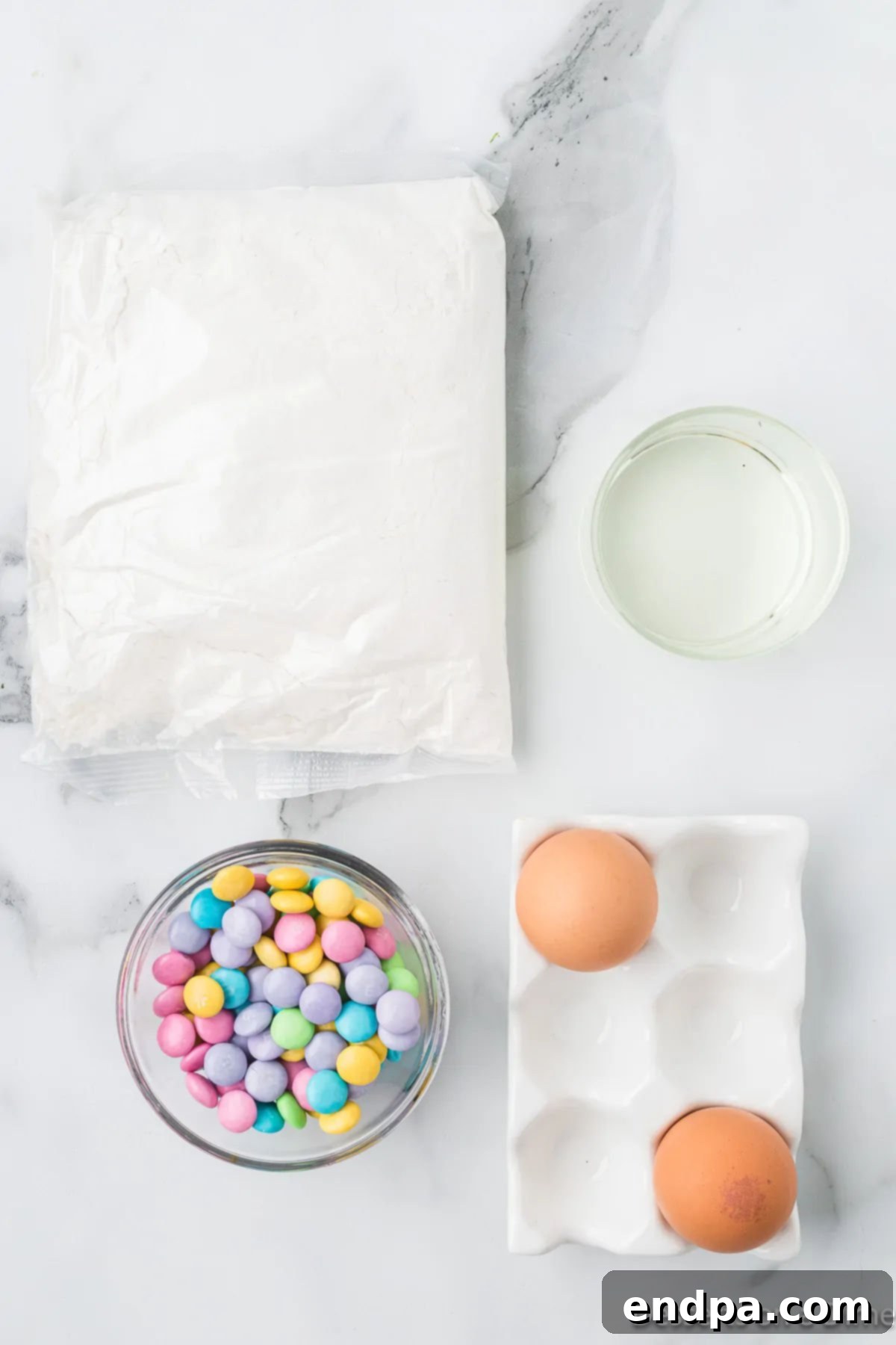 Ingredients for Easter cake mix cookies: yellow cake mix, eggs, vegetable oil, and pastel M&M's.