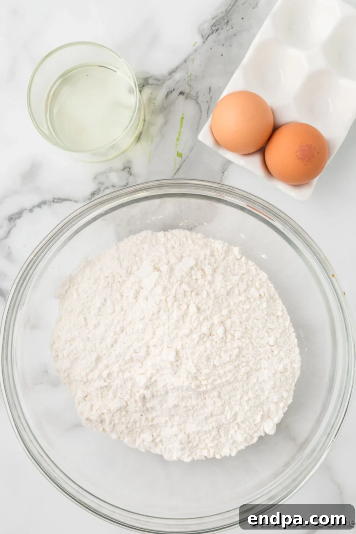 Yellow cake mix in a large mixing bowl, ready for ingredients.