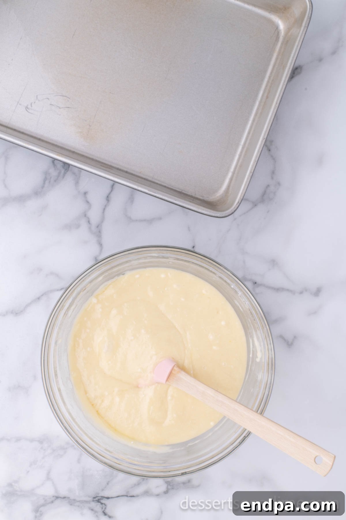 Romantic Valentines Poke Cake 4 Mixing bowl with cake mix combined, ready for baking.