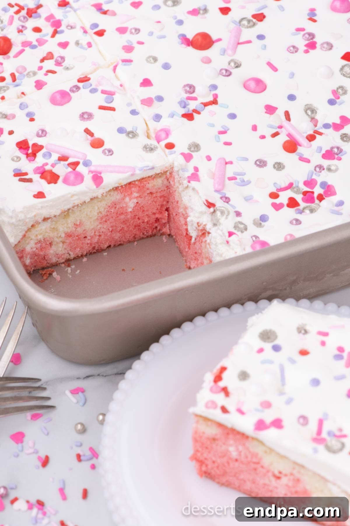 Romantic Valentines Poke Cake 8 Valentine's Day Poke Cake being served from its pan, ready to enjoy.