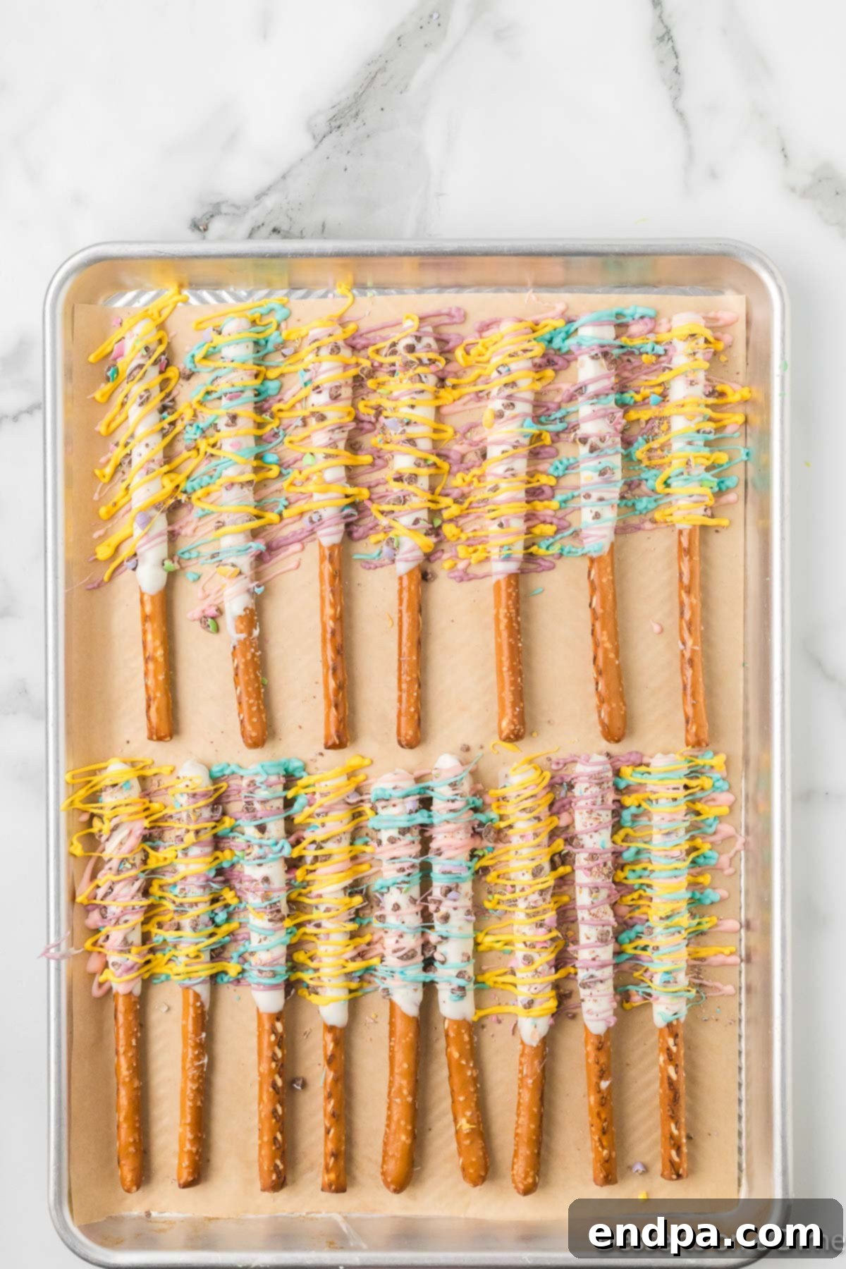 Candy melts drizzled over pretzels. 