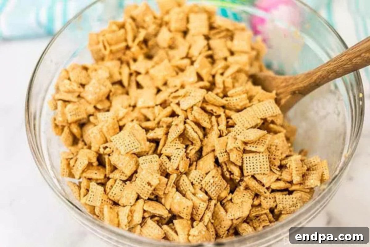 Cereal fully coated in peanut butter and chocolate mixture, ready for powdered sugar.