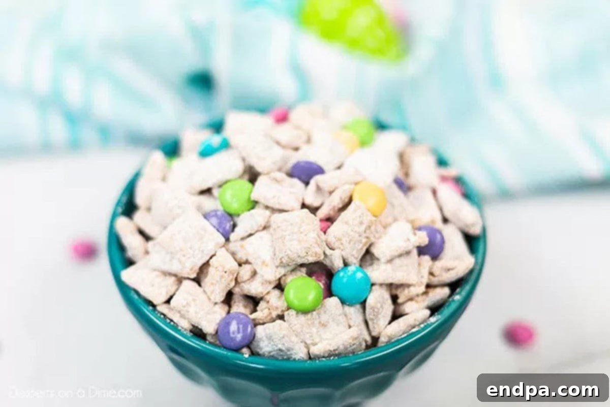 Close up bowl of bunny chow mix with powdered sugar coating and pastel M&M's.