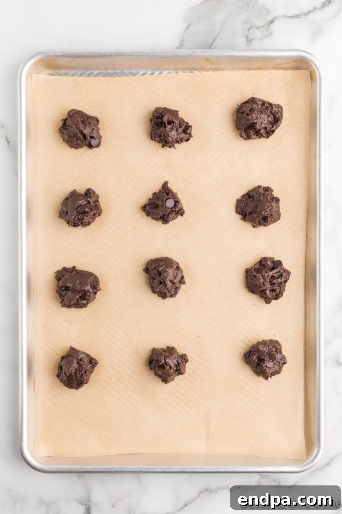 Fudgy Chocolate Cake Mix Cookies 7 Chocolate chips scooped on pan.