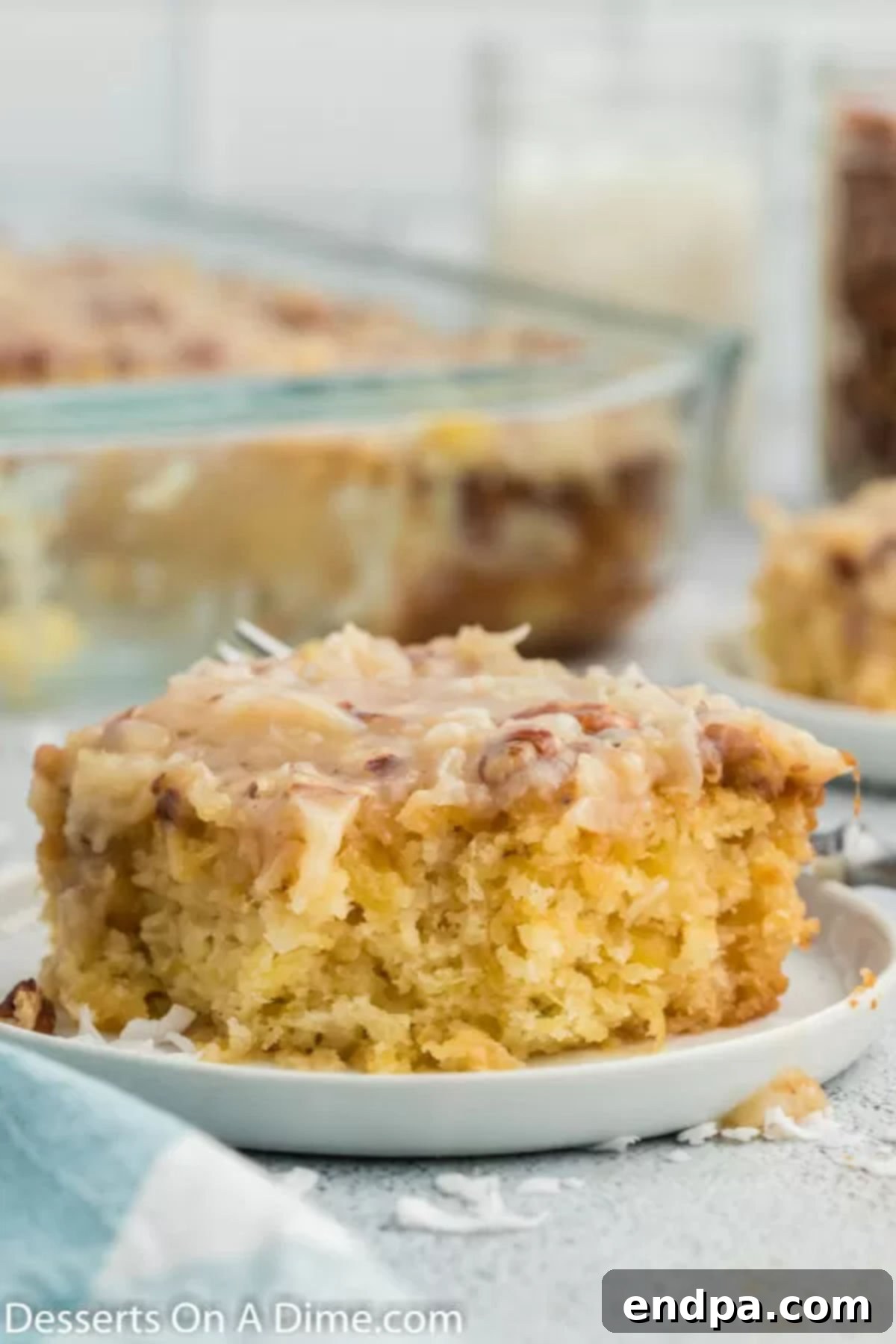 Tornado cake sliced on a plate, showcasing its moist texture and coconut topping.