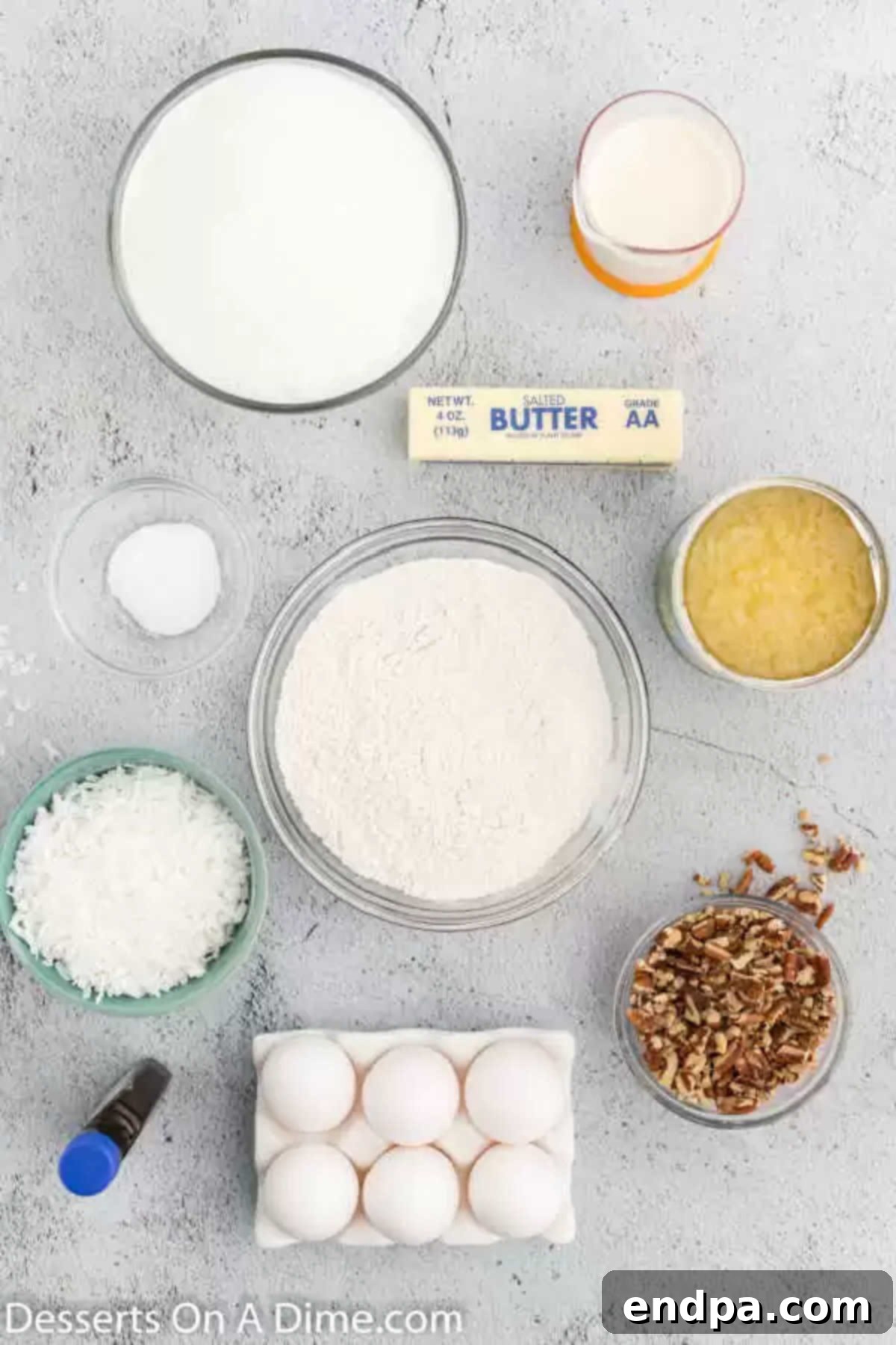 Ingredients for Tornado Cake recipe, including milk, sugar, pineapple, coconut, eggs, nuts, and butter laid out on a surface.