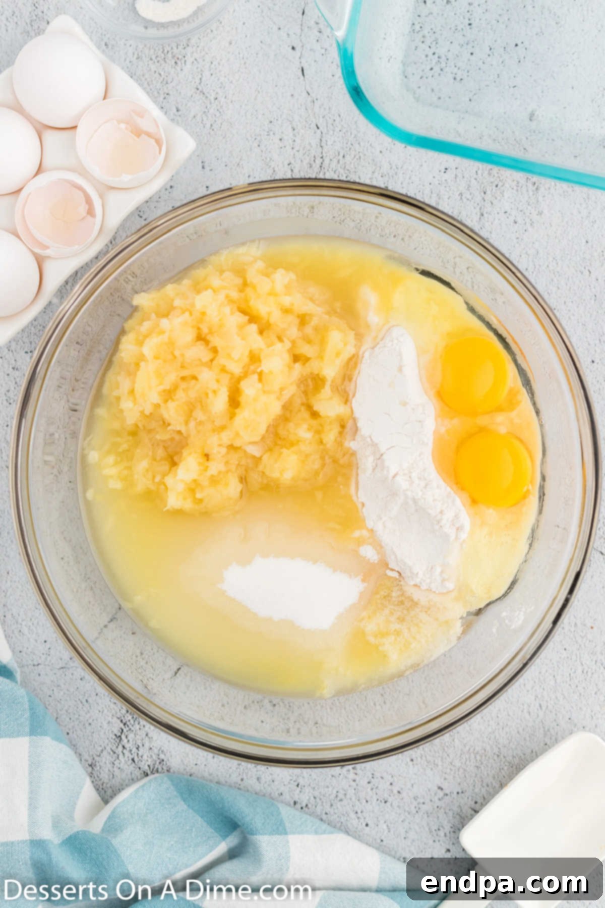 Mixing bowl with cake ingredients being combined to form a thick batter.