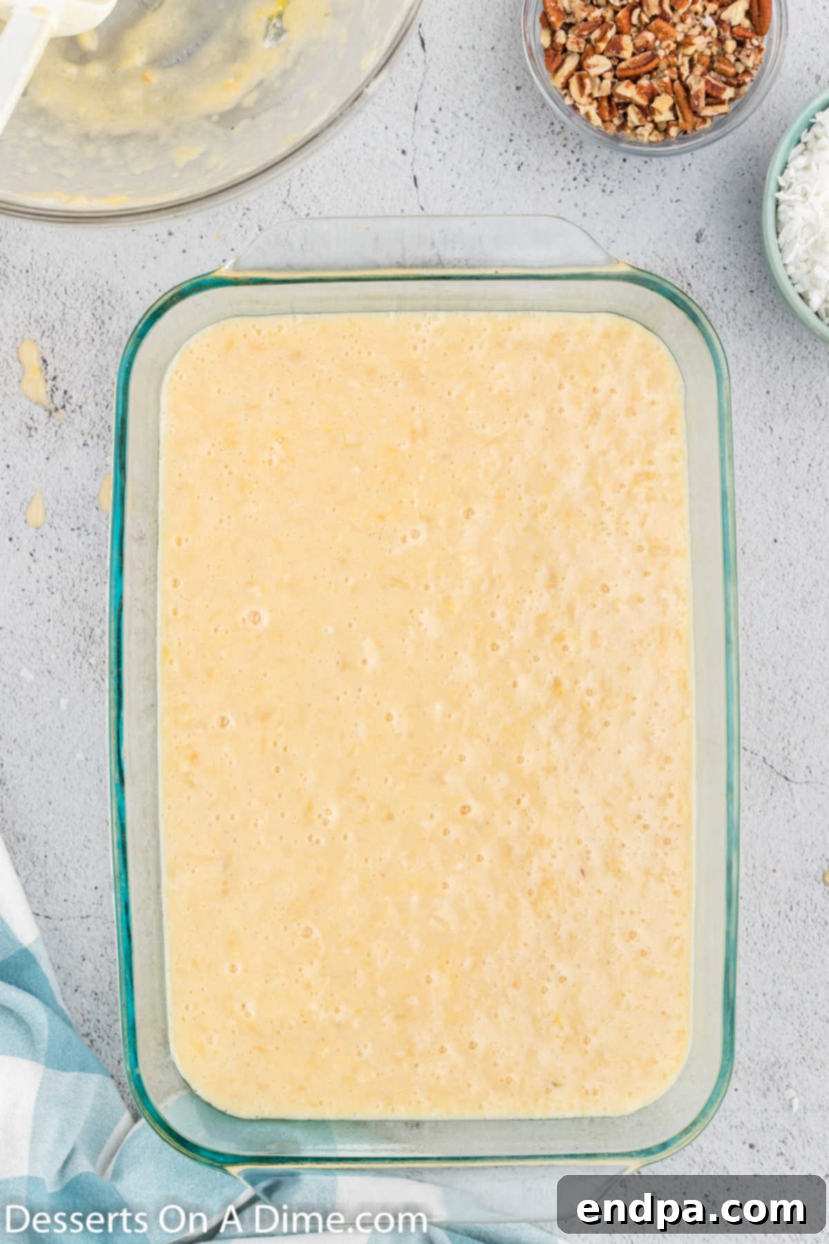 Thick cake batter spread evenly in a 9x13 inch baking dish, ready for baking.