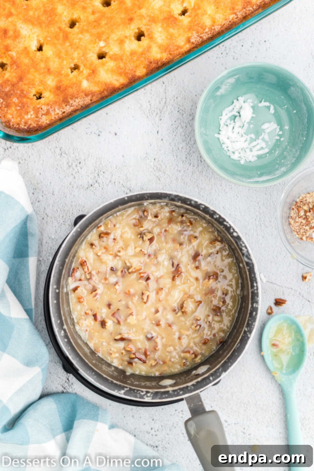 Saucepan containing evaporated milk, sugar, butter, and vanilla extract simmering on the stove for the topping.