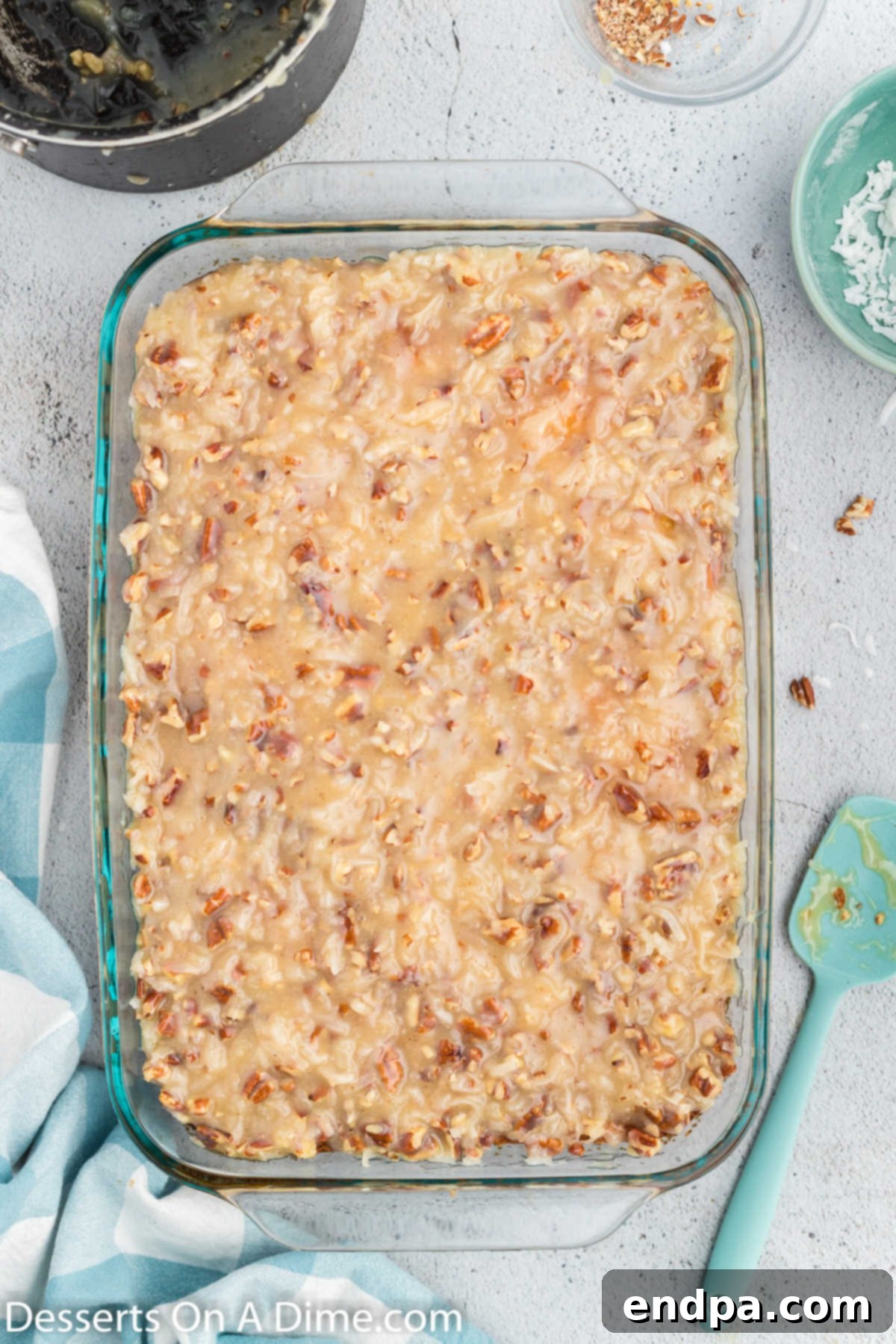 Tornado cake with its complete coconut and pecan topping, ready to be cooled and served.