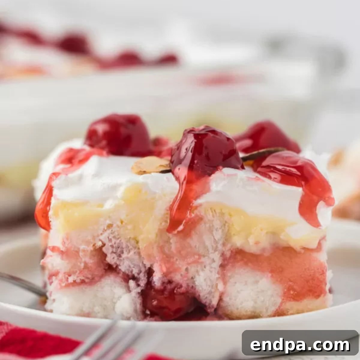 A square image of a perfect slice of Heaven on Earth Cake, highlighting its layers and delicious appearance.