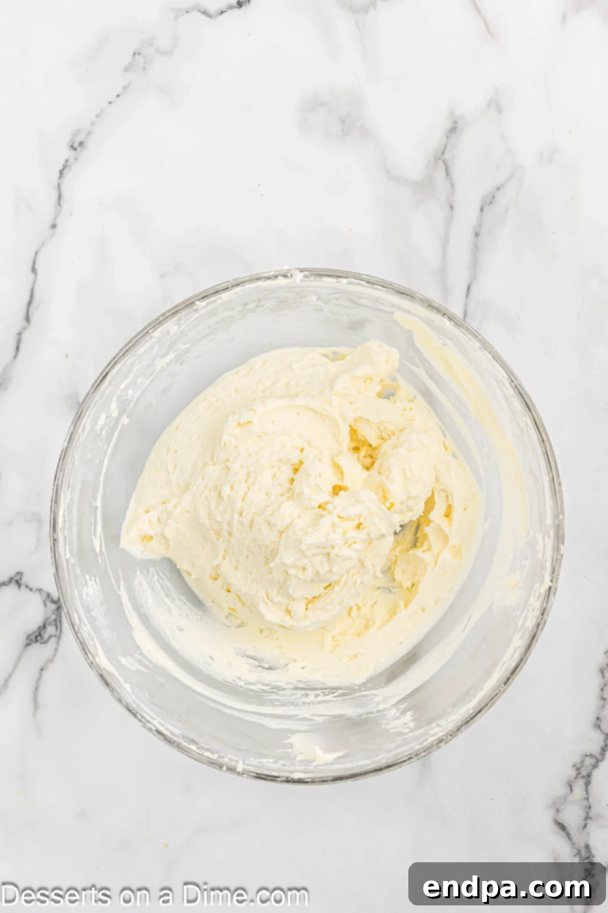 A bowl of light and fluffy keto cream cheese frosting ready to be used.