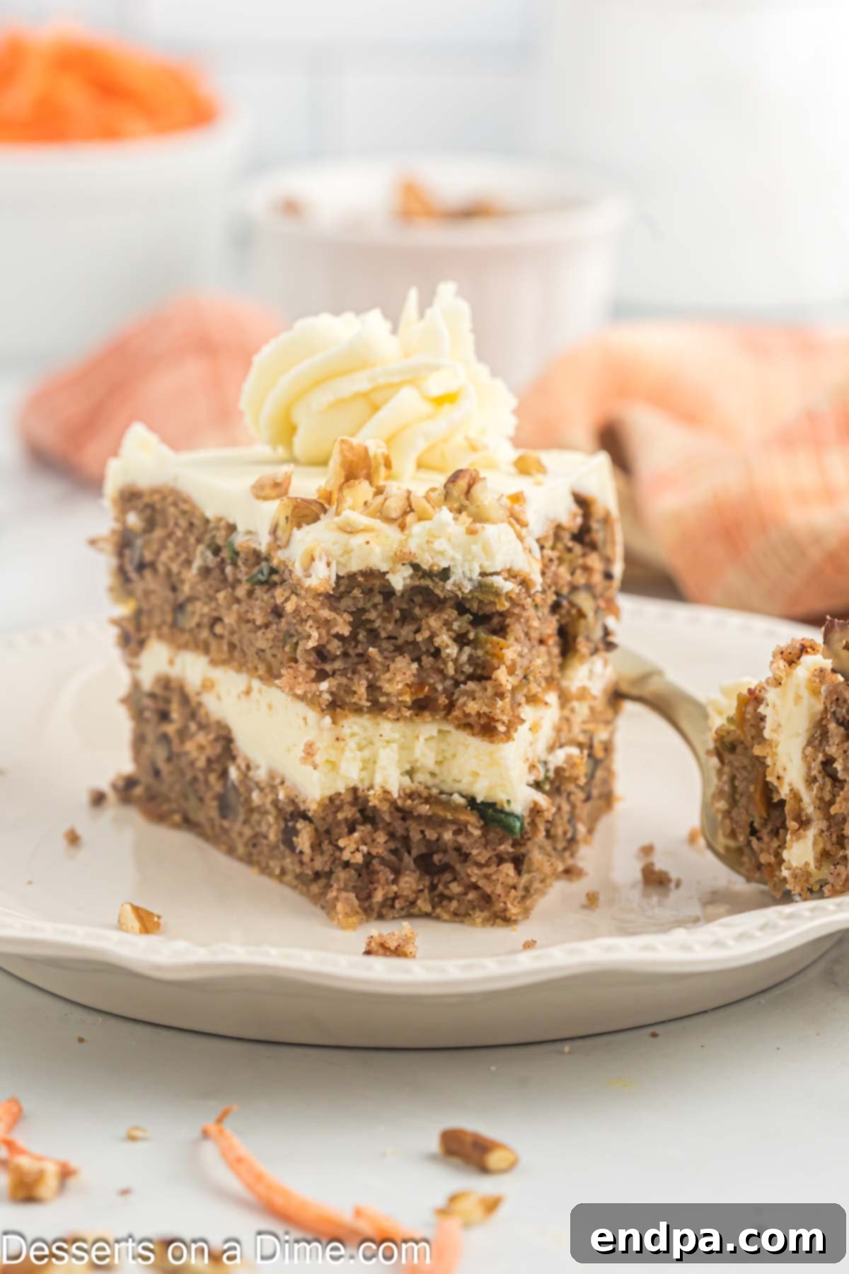 A perfect slice of Keto Carrot Cake with frosting on a plate, ready to be enjoyed.