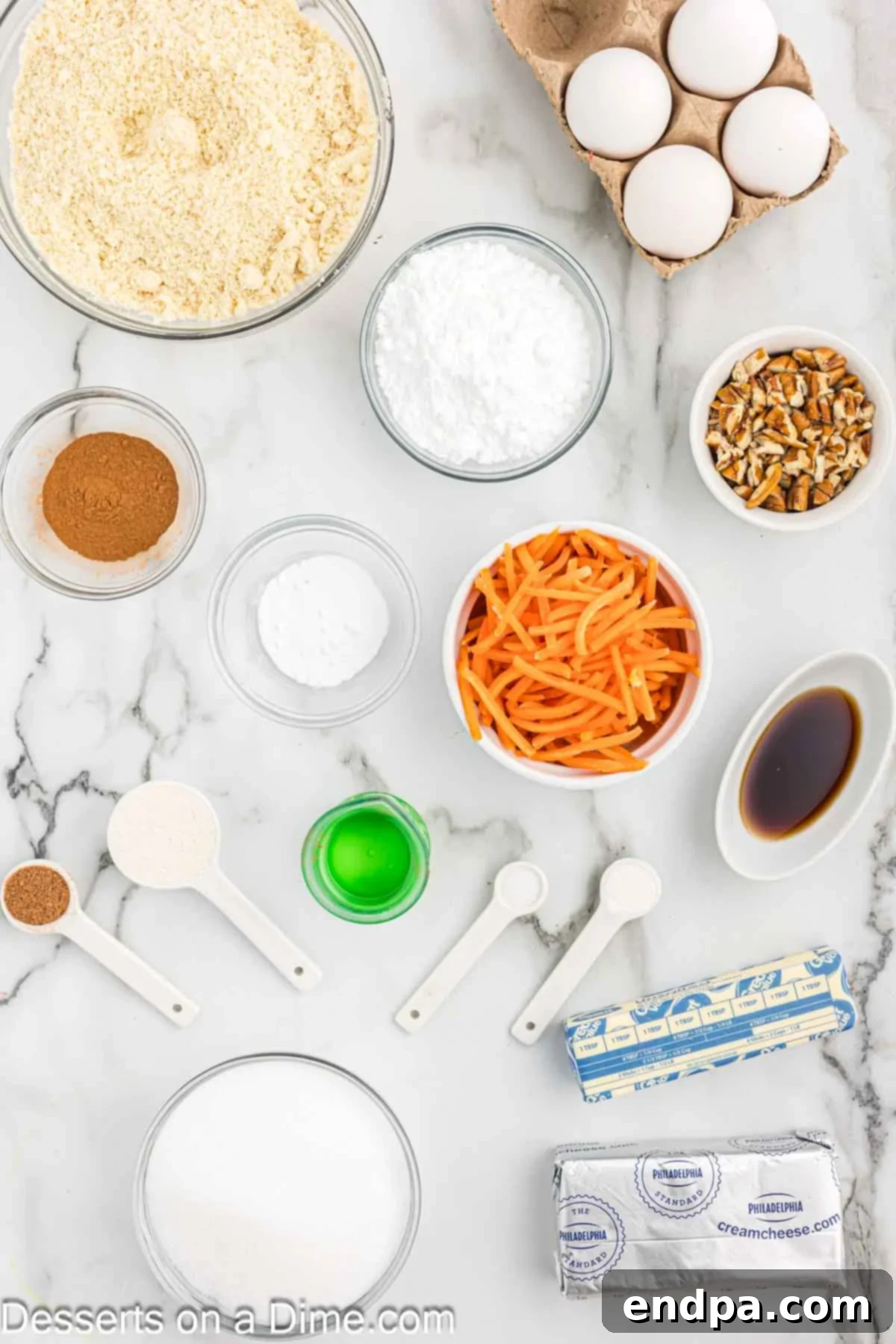 Ingredients for Keto Carrot Cake including eggs, coconut oil, vanilla extract, monk fruit sweetener, almond flour, coconut flour, baking soda, baking powder, nutmeg, cinnamon, salt, butter, pecans, and freshly shredded carrots.