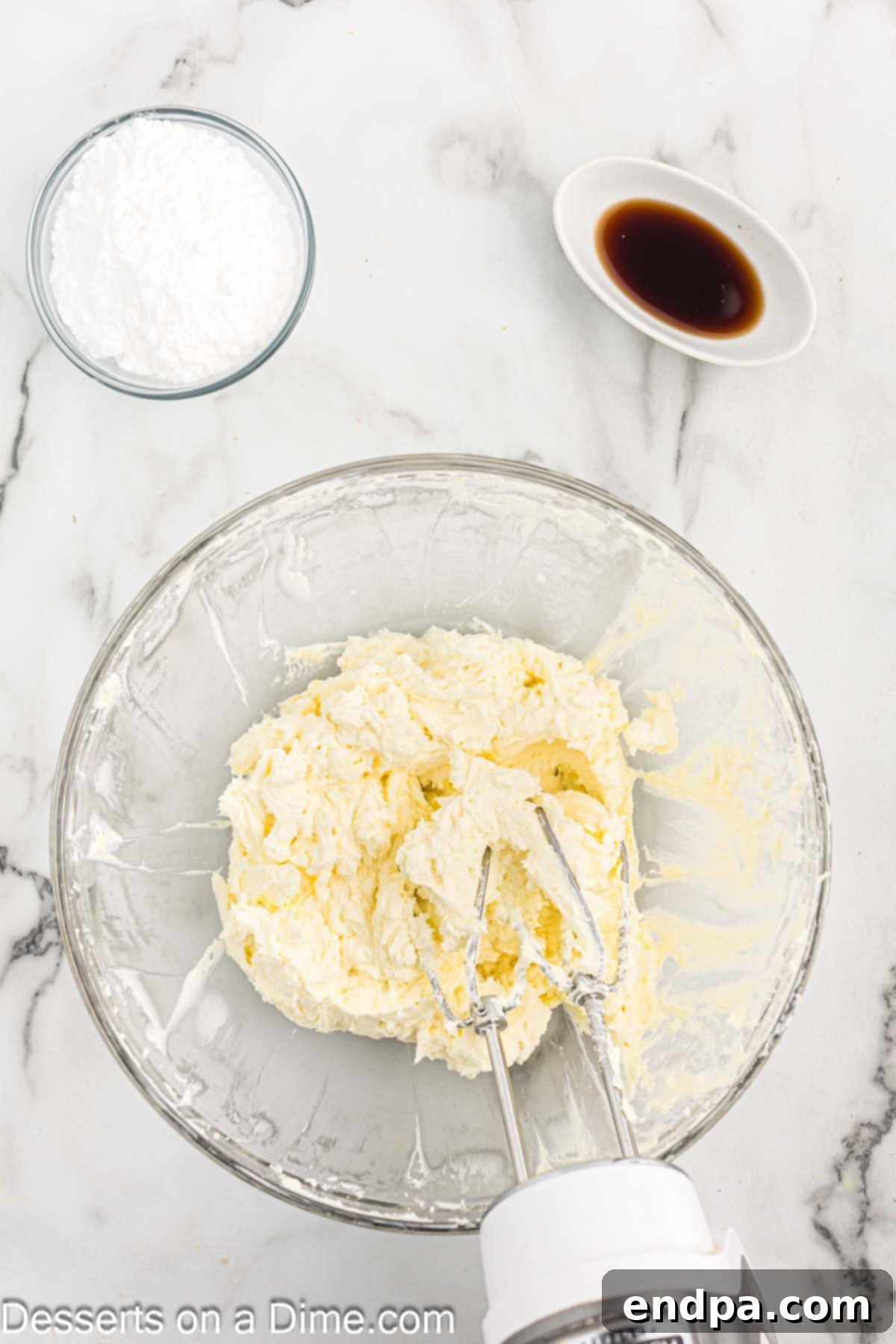 Cream cheese, butter, powdered erythritol, and vanilla extract combined in a bowl for the frosting.