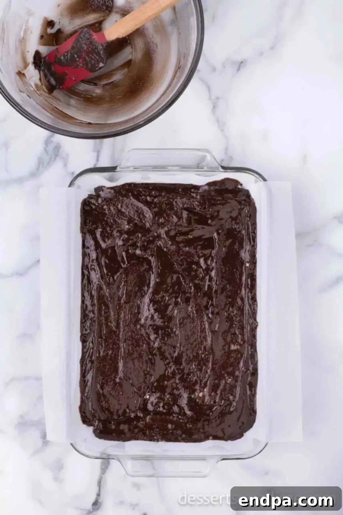 Brownie mixture spread in pan.