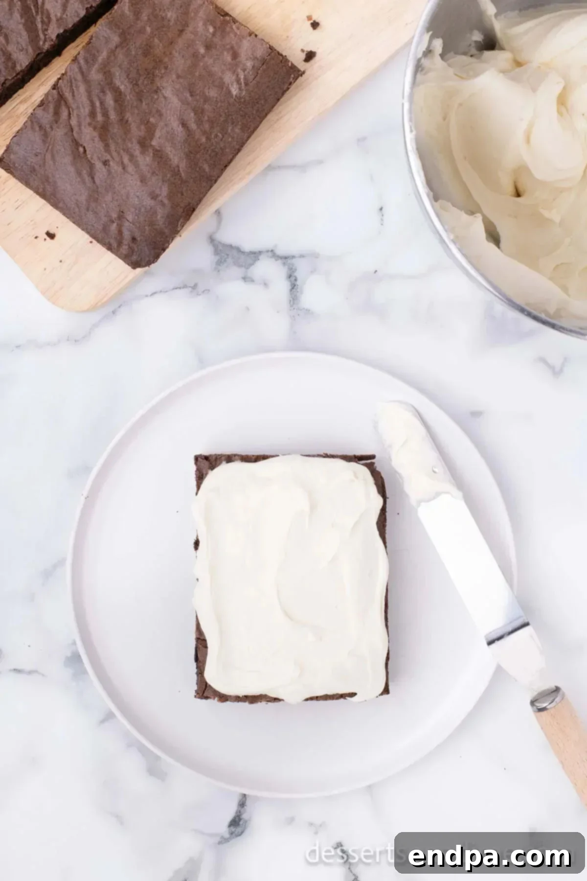 Cream cheese mixture spread on brownie layer.