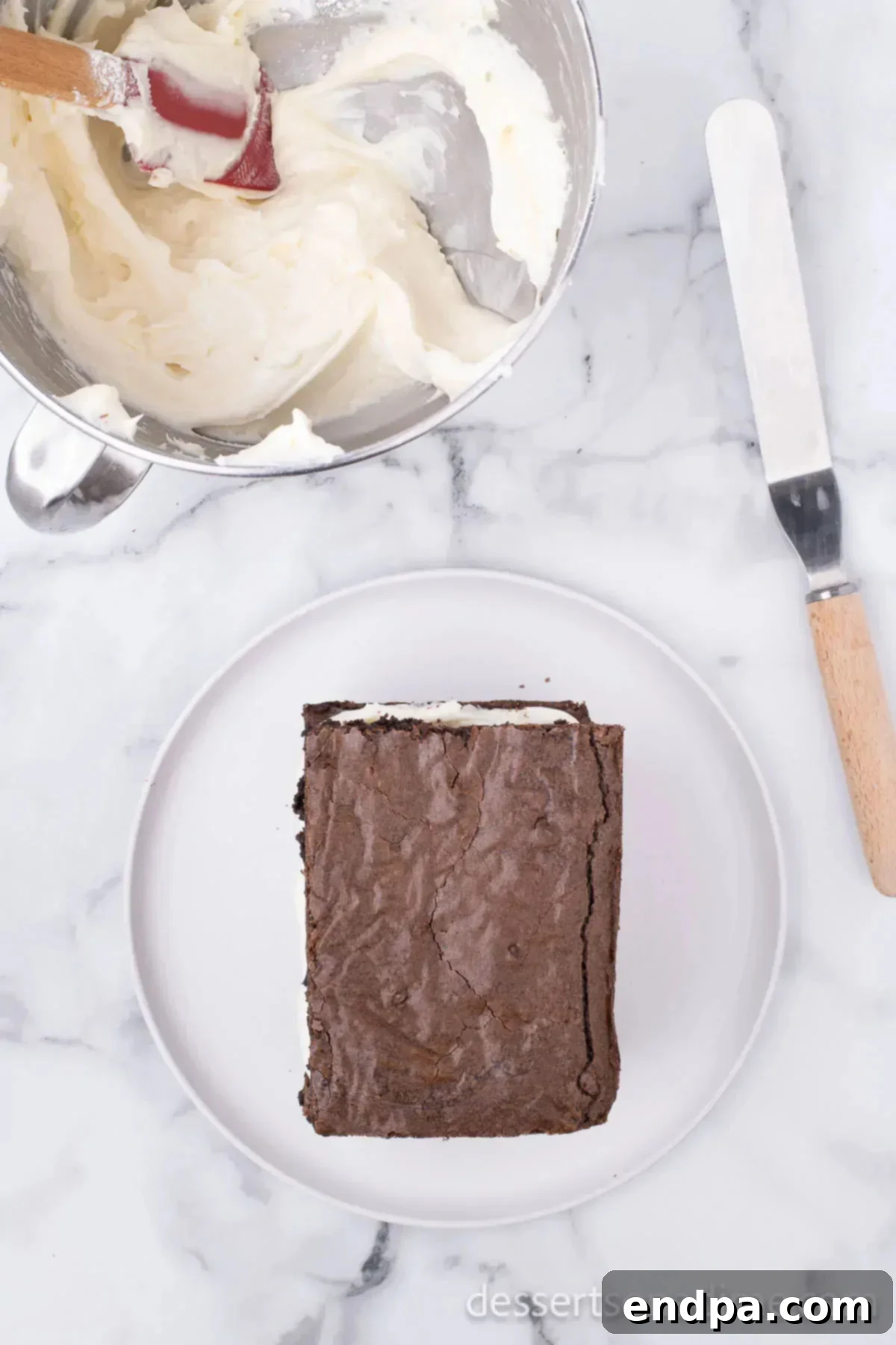 Brownie on top of cream cheese mixture.