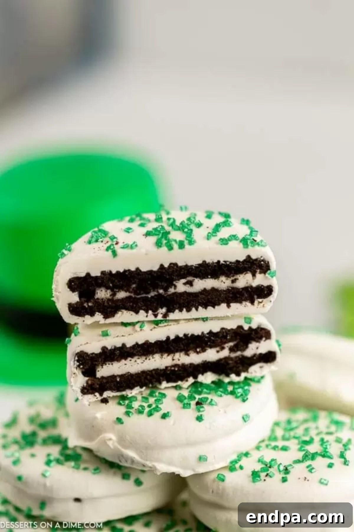Pot O' Gold Chocolate Oreos 6 St. Patrick's Day Chocolate Covered Oreos stacked and cut in half, revealing the cookie inside.