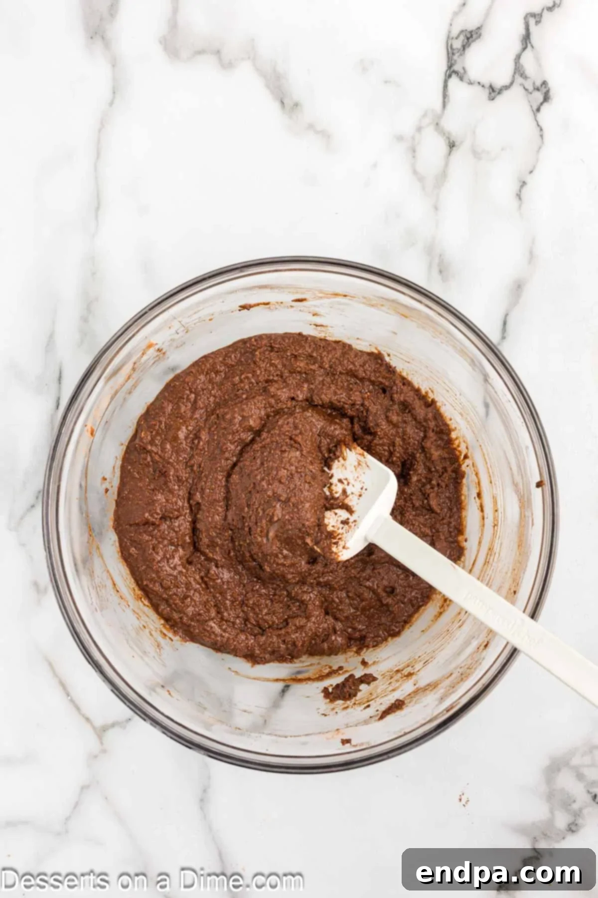 Decadent Keto Chocolate Dream 5 Smooth, rich chocolate cake batter in a mixing bowl, showing its readiness to be poured into the prepared pan for baking.