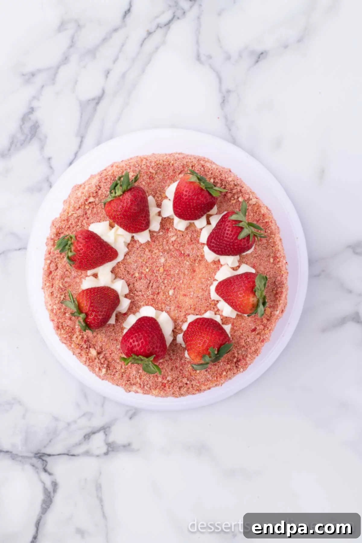 Decorated Strawberry Crunch Cake topped with fresh strawberries and the crunch topping.