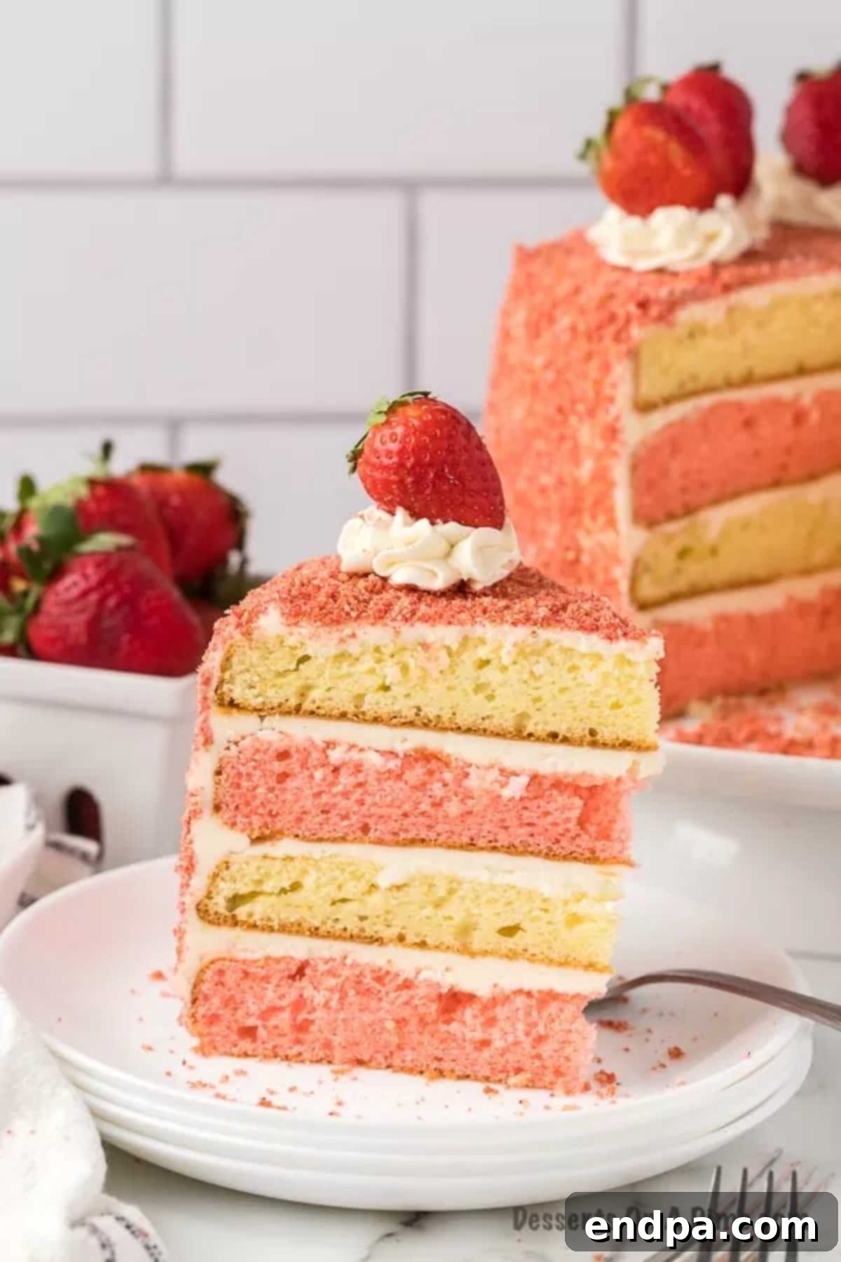 A delicious slice of Strawberry Crunch Cake on a plate, ready to be enjoyed.