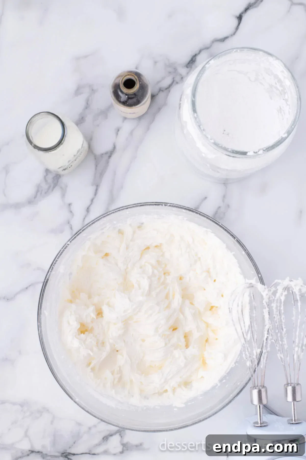 Mixing bowl with softened butter and powdered sugar for buttercream icing.