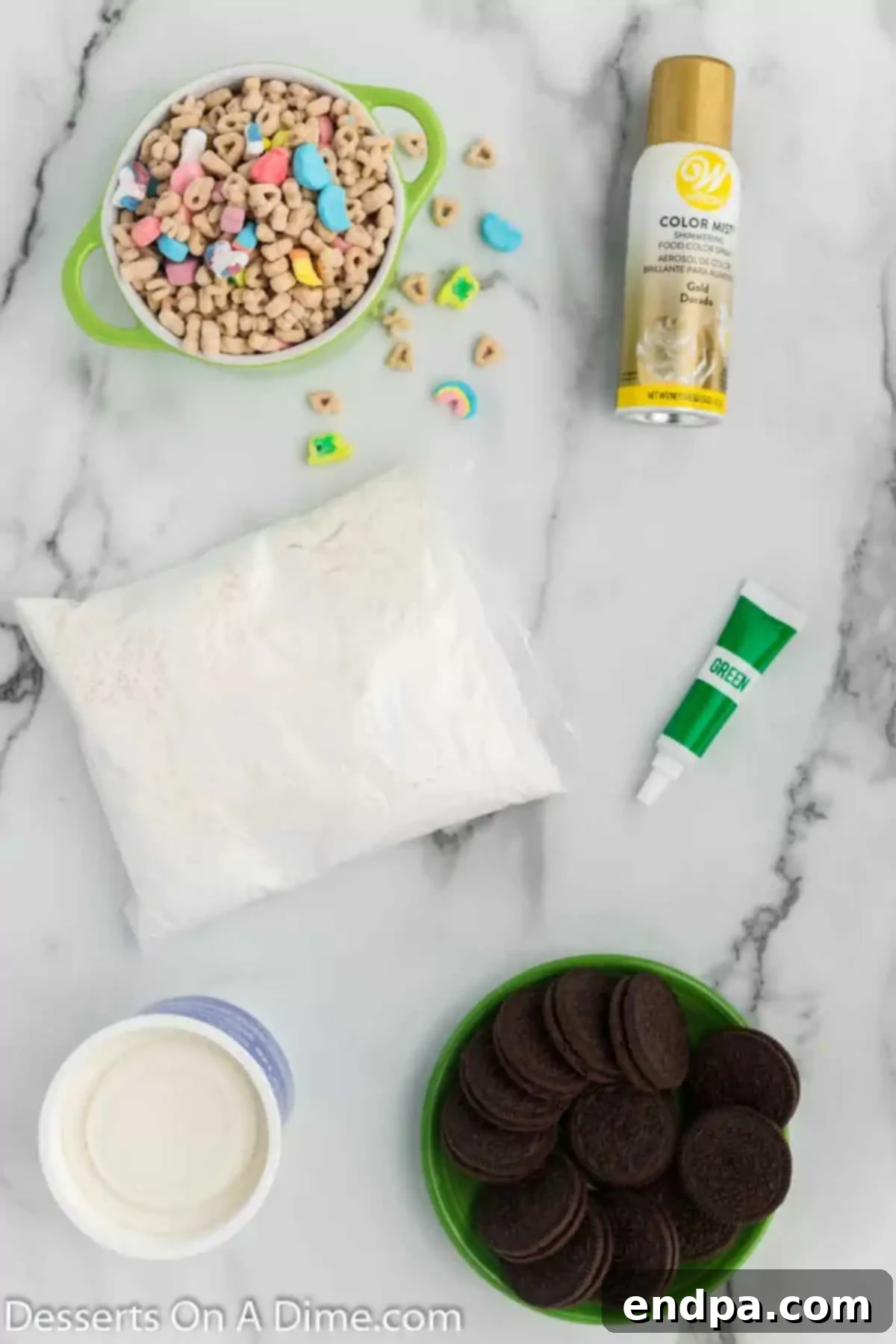 Lucky Green Cupcake Delights 3 Collection of ingredients for St. Patrick's Day Cupcakes, including white cake mix, gel food coloring, white frosting, Oreo cookies, Wilton gold mist, and Lucky Charms cereal.