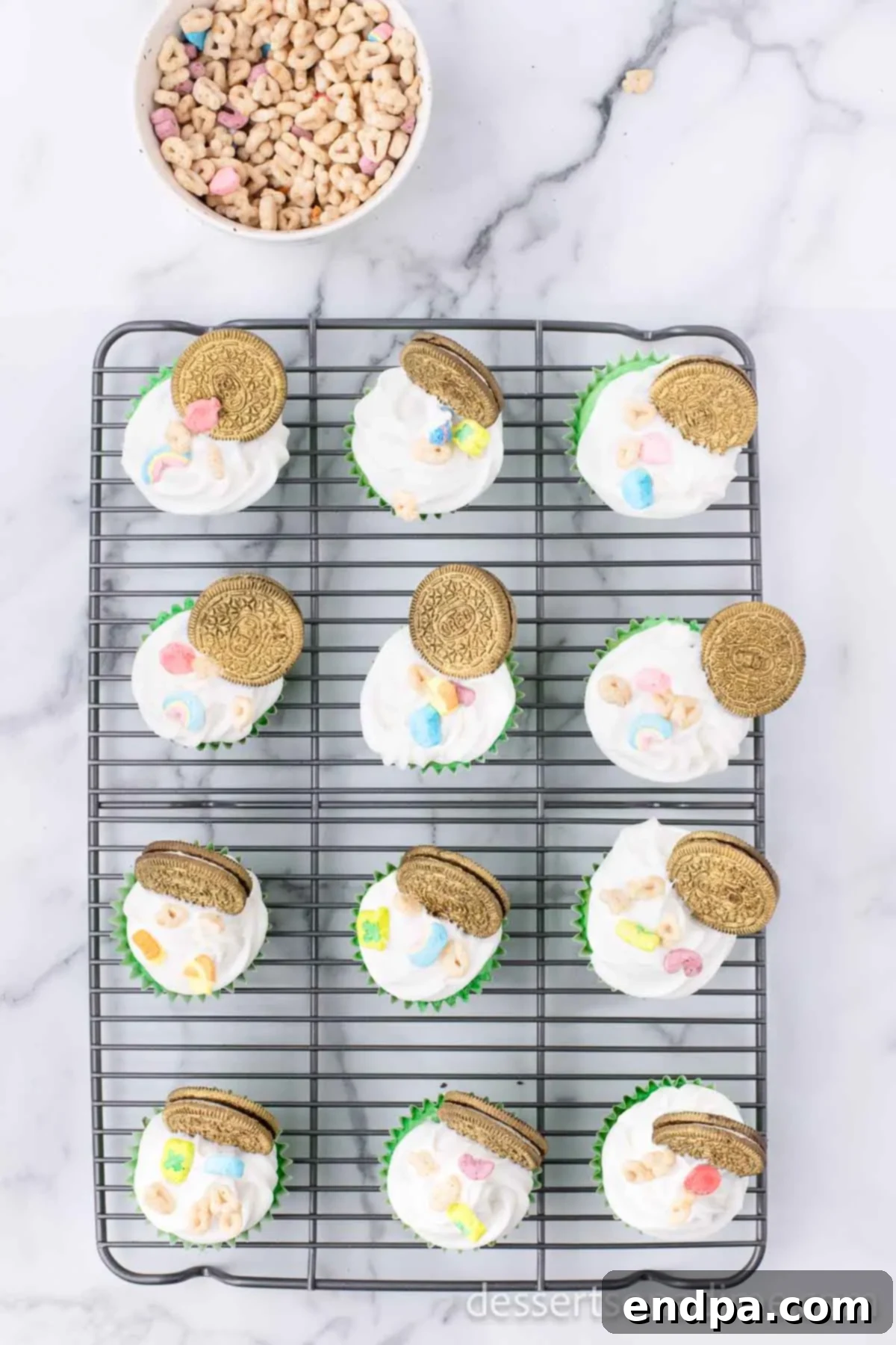 Lucky Green Cupcake Delights 8 Lucky Charm cereal marshmallows sprinkled on top of frosted and golden Oreo topped cupcakes.
