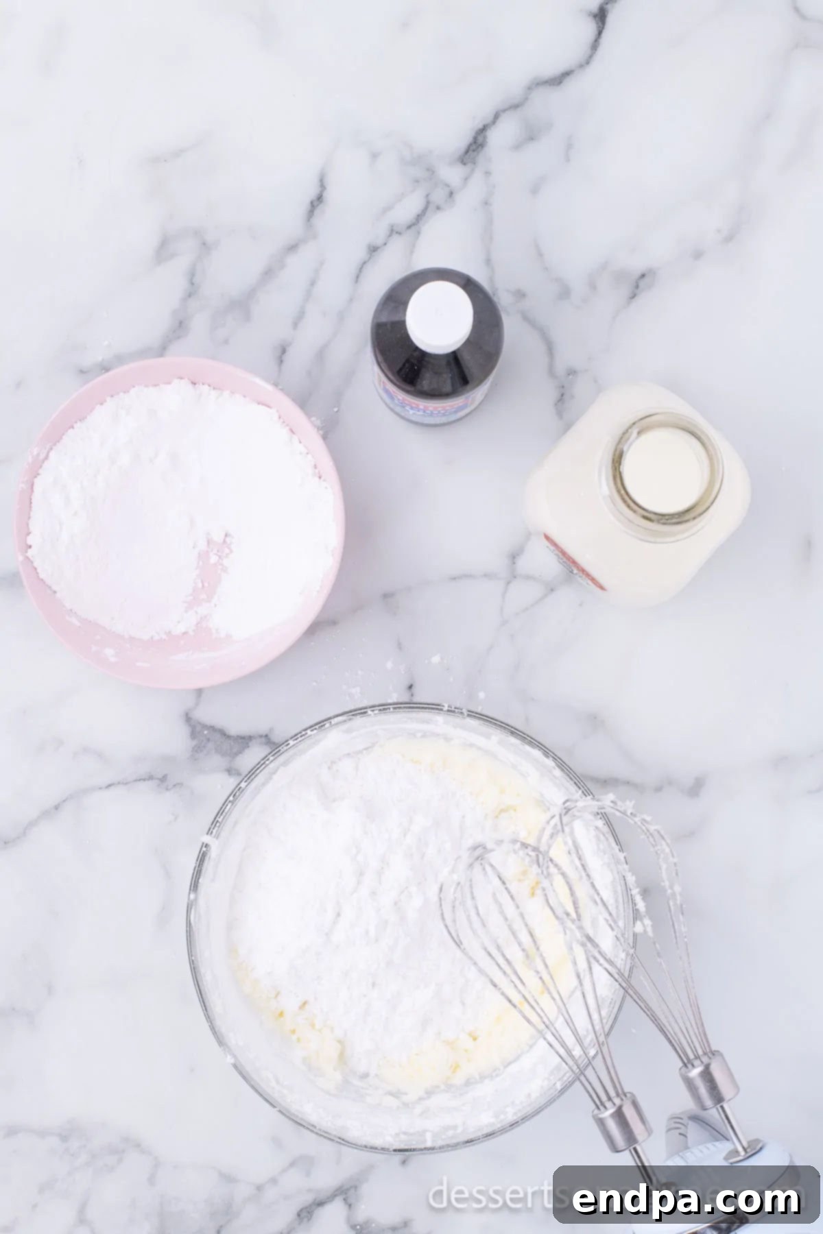 Mixing bowl with ingredients for vanilla buttercream frosting.