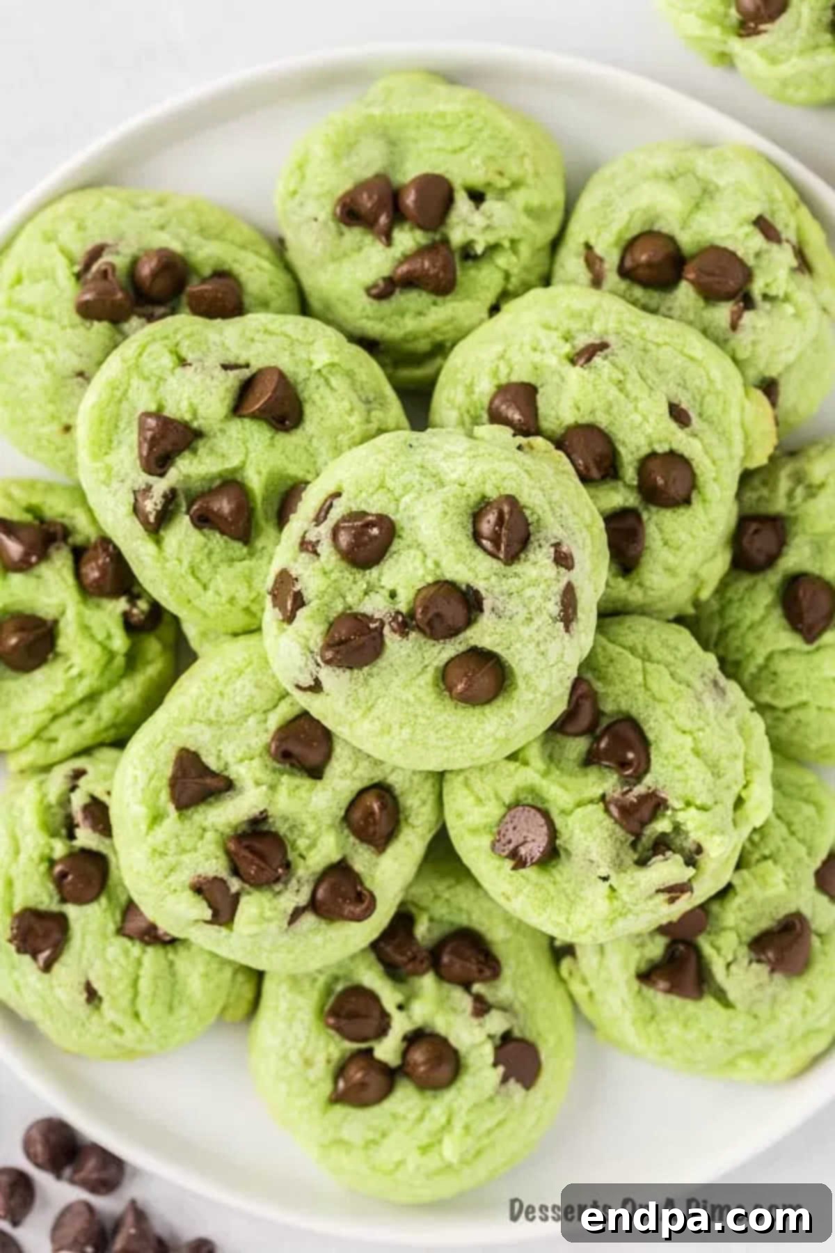 Cooling mint chocolate chip cookies on a wire rack after being removed from the oven.