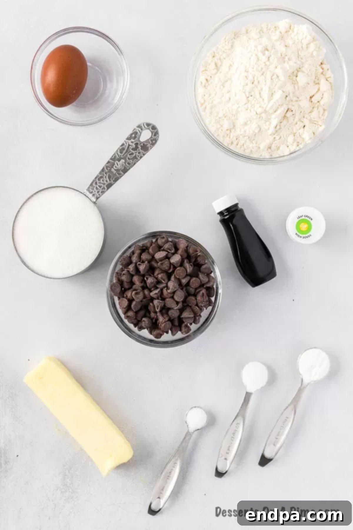 Essential ingredients for baking: eggs, all-purpose flour, granulated sugar, semi-sweet chocolate chips, and softened butter.