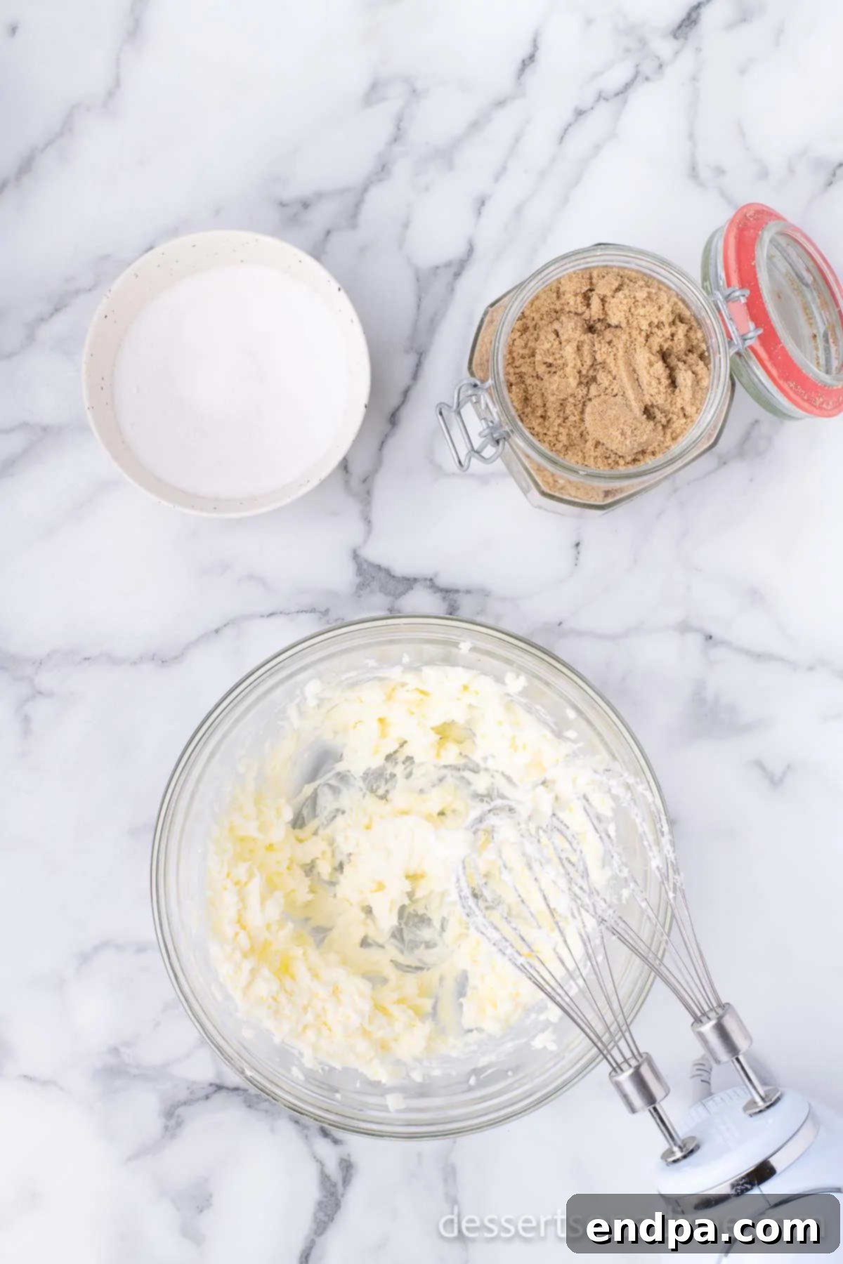 Creaming softened butter and granulated sugar together in a mixing bowl until light and fluffy.
