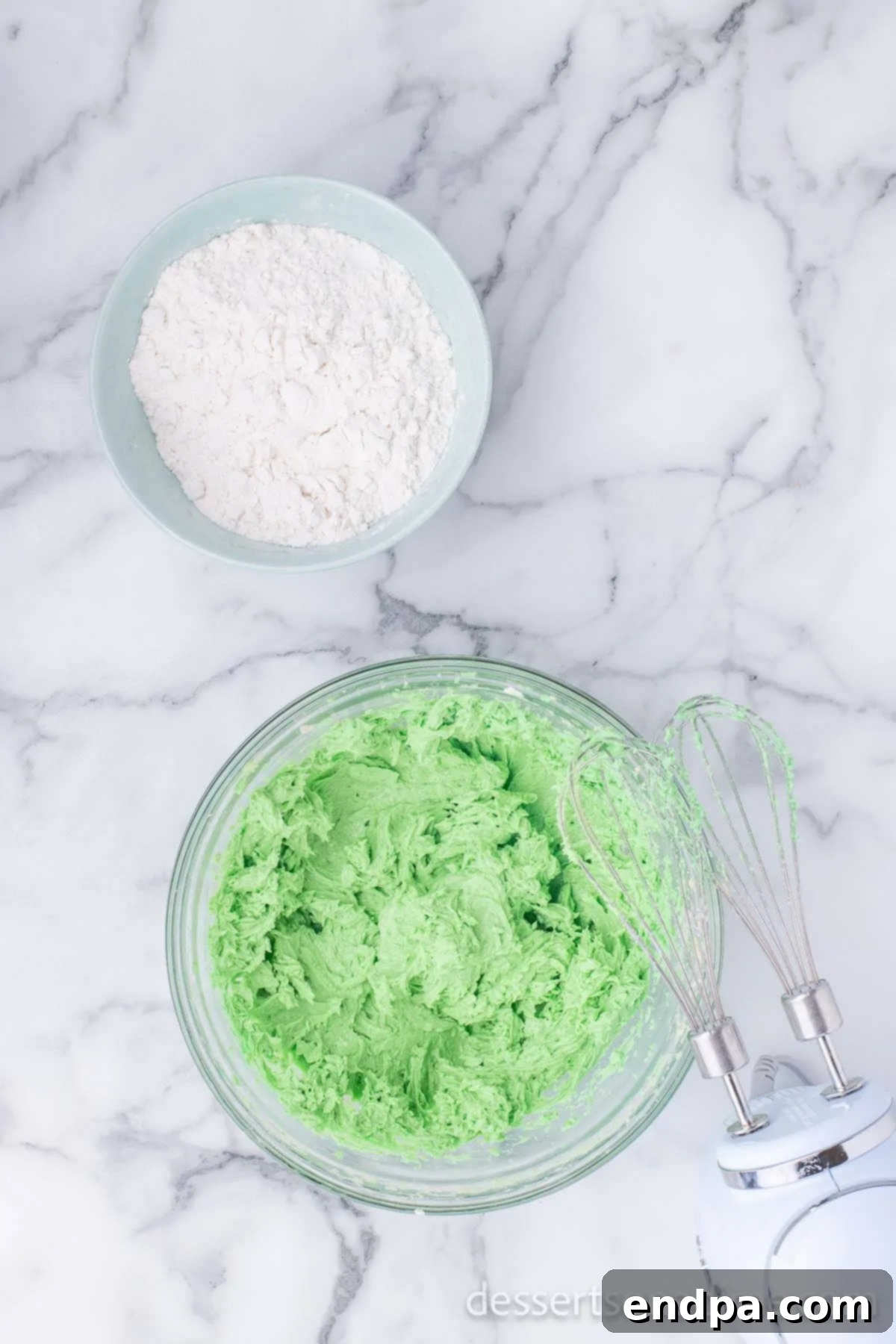 Adding green gel food coloring and peppermint extract to the wet ingredients for vibrant color and minty flavor.