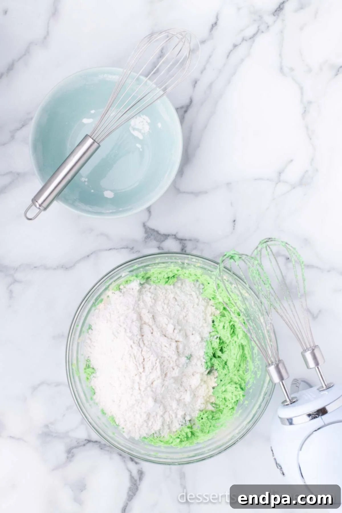 Gradually adding dry ingredients (flour, baking powder, baking soda, salt) to the wet mixture.