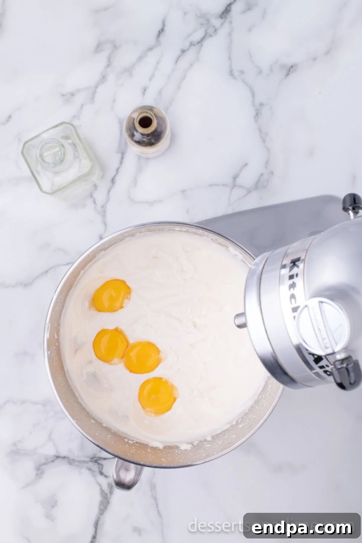 Separate mixing bowl with butter and sugar combined. Egg yolks added to mixture.