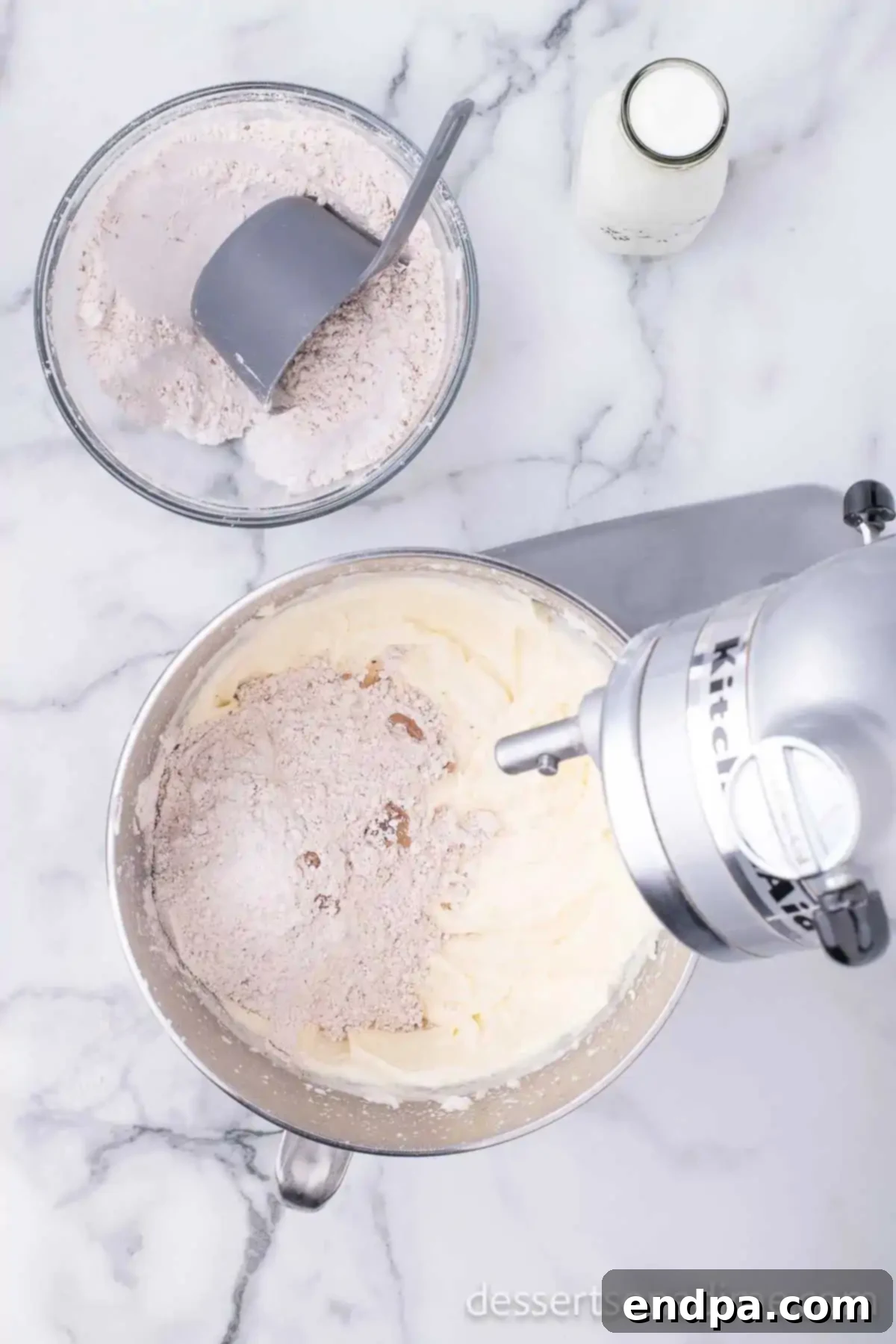 Wet and dry ingredients being combined in a mixing bowl.