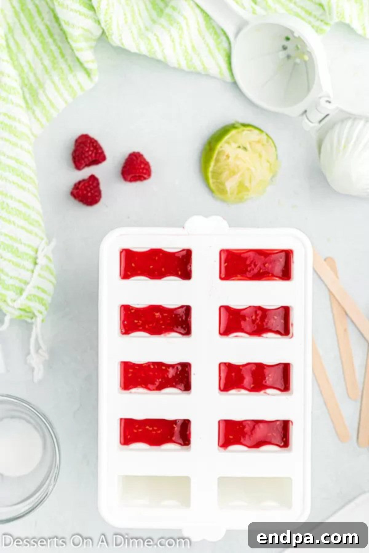 Bursting Berry Bliss: Homemade Raspberry Pops 5 Mixture poured into molds.