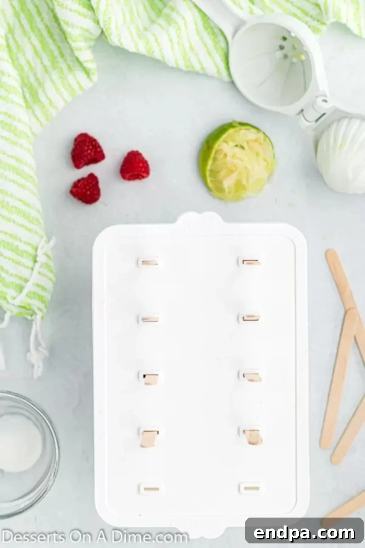 Bursting Berry Bliss: Homemade Raspberry Pops 6 Popsicle sticks inserted into molds.