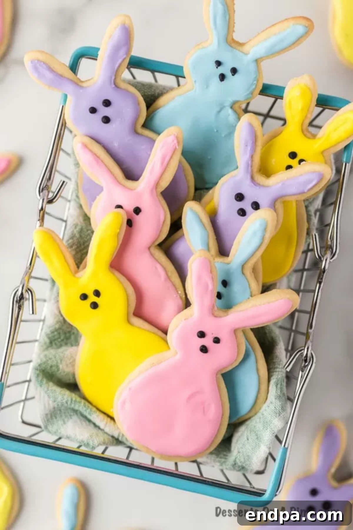 Hoppy Easter Cookie Creations 2 A basket filled with intricately decorated Easter bunny cookies, showcasing pastel royal icing and charming bunny faces.