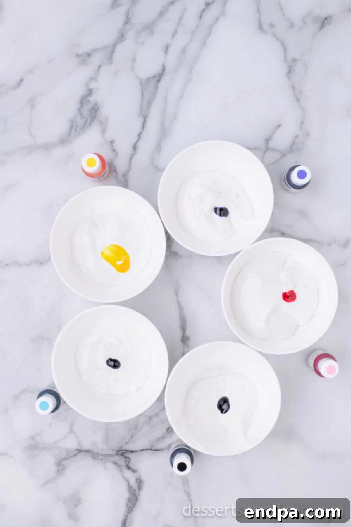 Hoppy Easter Cookie Creations 11 Small bowls containing royal icing in various pastel colors, ready for piping onto cookies.